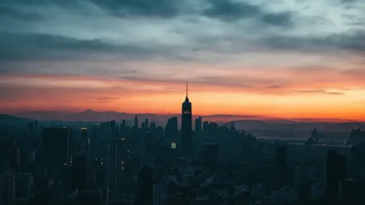 A dramatic image of a city skyline at dusk, with faint tremors visible, hinting at an impending natural disaster. News headlines about earthquakes are subtly overlaid.