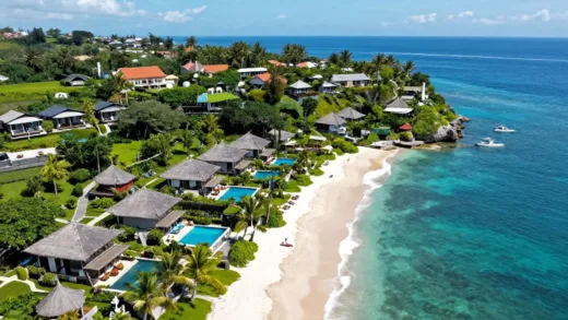 A stunning aerial view of Bali's coastline with luxurious resorts, bright blue ocean, and lush greenery, hinting at an affordable yet high-end travel experience.