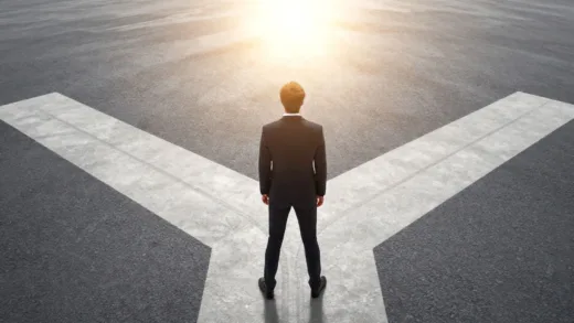 A person standing confidently at a crossroads with a clear path ahead, sun shining, representing decision-making and a bright future.