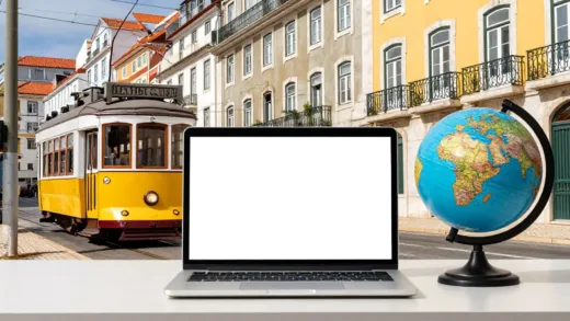 A vibrant image of Lisbon with its iconic trams and historic buildings, subtly incorporating elements of modern remote work like a laptop and a globe, symbolizing global reach and digital transformation.