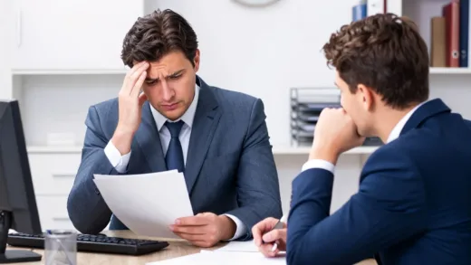 A professional office environment with a worried boss looking at documents while a subordinate makes a decision without consultation, showing tension in workplace relationships