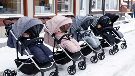 A scene of multiple baby strollers lined up outdoors in a snowy, cold Nordic street, with babies peacefully sleeping inside the strollers, highlighting the unique outdoor napping culture.