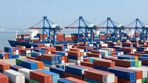 Vibrant, high-angle shot of a bustling port with numerous container ships and a vast array of stacked, colorful shipping containers under a bright sky, emphasizing global trade and scale.