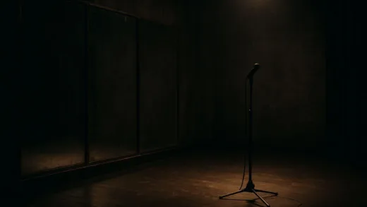 A dimly lit practice room with abandoned dance mirrors and a lonely microphone, representing the harsh reality of disbanded K-pop idols, cinematic lighting, moody atmosphere