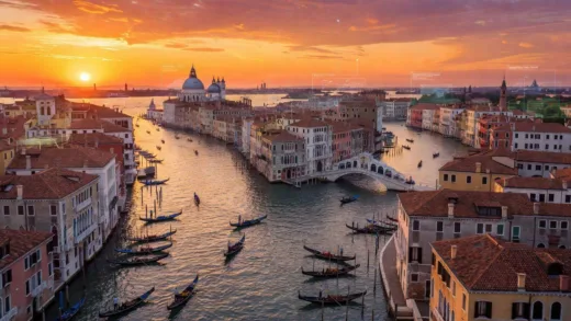 A stunning aerial view of Venice at sunset, showing its canals, historic buildings, and gondolas, with a subtle overlay hinting at a modern challenge.