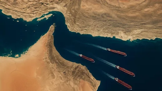 Aerial view of the Strait of Hormuz with oil tankers navigating the narrow waterway, showing geopolitical tension and economic dependency concept