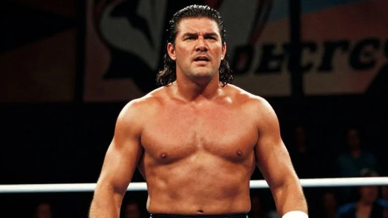 A vintage-style photo of a strong, determined professional wrestler in a ring, with a shadowy, slightly ominous background suggesting a family legacy. The wrestler has a powerful build.