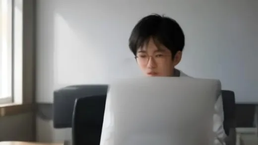 A confident Korean entrepreneur in a bright modern office, split composition showing corporate desk work transforming into a small startup business, symbolizing work ethic carrying over after quitting a job, warm natural light, photorealistic style