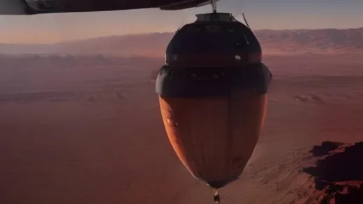 A high-tech space capsule with a parachute descending slowly over a vast, reddish desert in Utah, sunrise light, scientific instruments visible, small asteroid sample container inside.