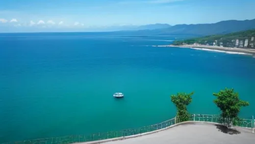 A vibrant, clear photo of a ferry approaching Udo island from Jeju, with emerald green water and a blue sky. Many excited tourists are visible on the deck.